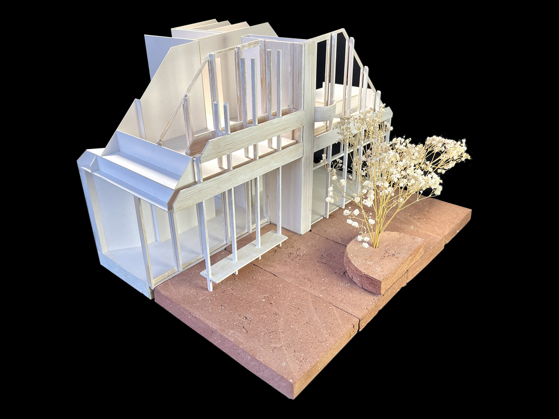 Architekturmodell aus weißer Pappe und aufgeschnittenenen Ziegelsteinen